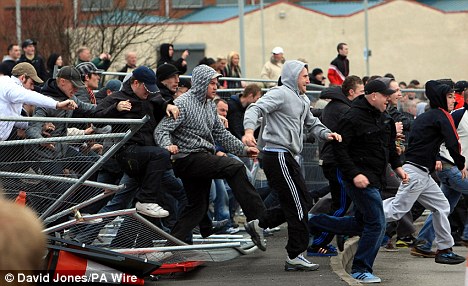 Clashes: English Defence League protesters break through barriers during a demonstration through the streets of Dudley  (Photo: Daily Mail/PA Wire - David Jones) 